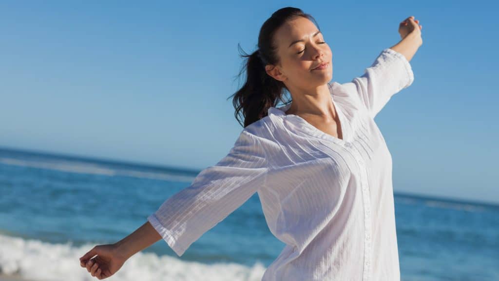 Woman enjoying the beach breeze.
